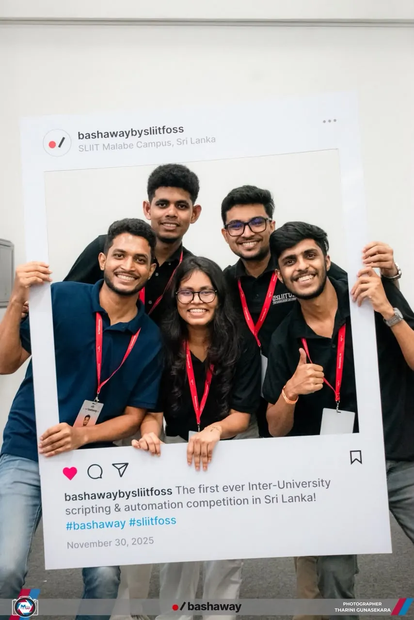 Five Bashaway organizers smiling and posing together inside a large social media photo frame