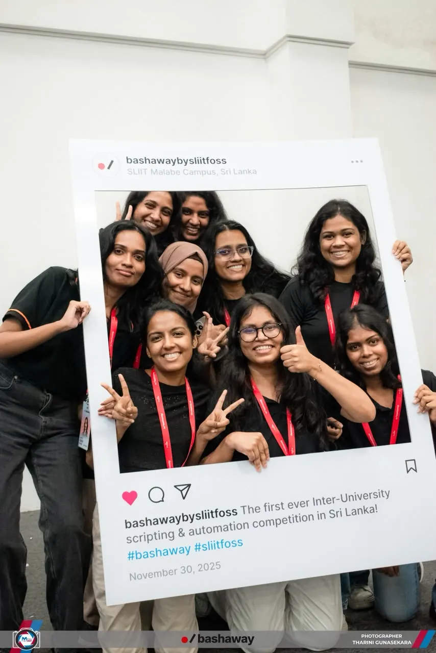 Group of smiling participants posing inside a photo frame at Bashaway, the inter-university scripting competition